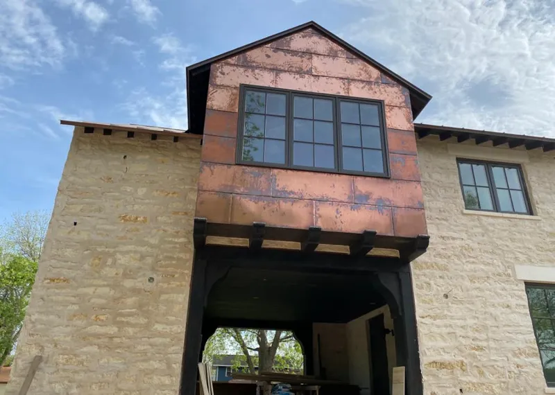 Copper metal panel facade on a stone building for Metal Roof Coating in Salida